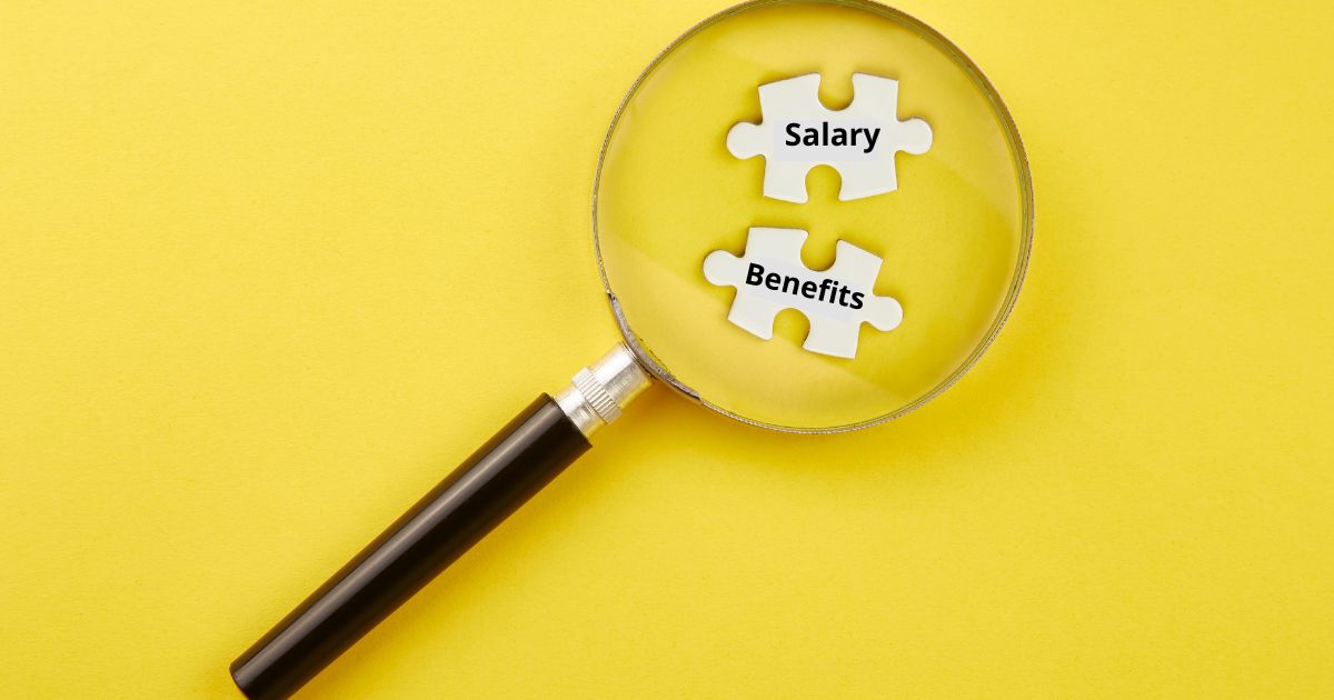 Do today’s job candidates care more about salary or benefits, magnifying glass with puzzle pieces with the words salary or benefits