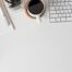 Tips for Writing Job Descriptions photo of a white desk with keyboard and coffee belonging to recruiting consultant